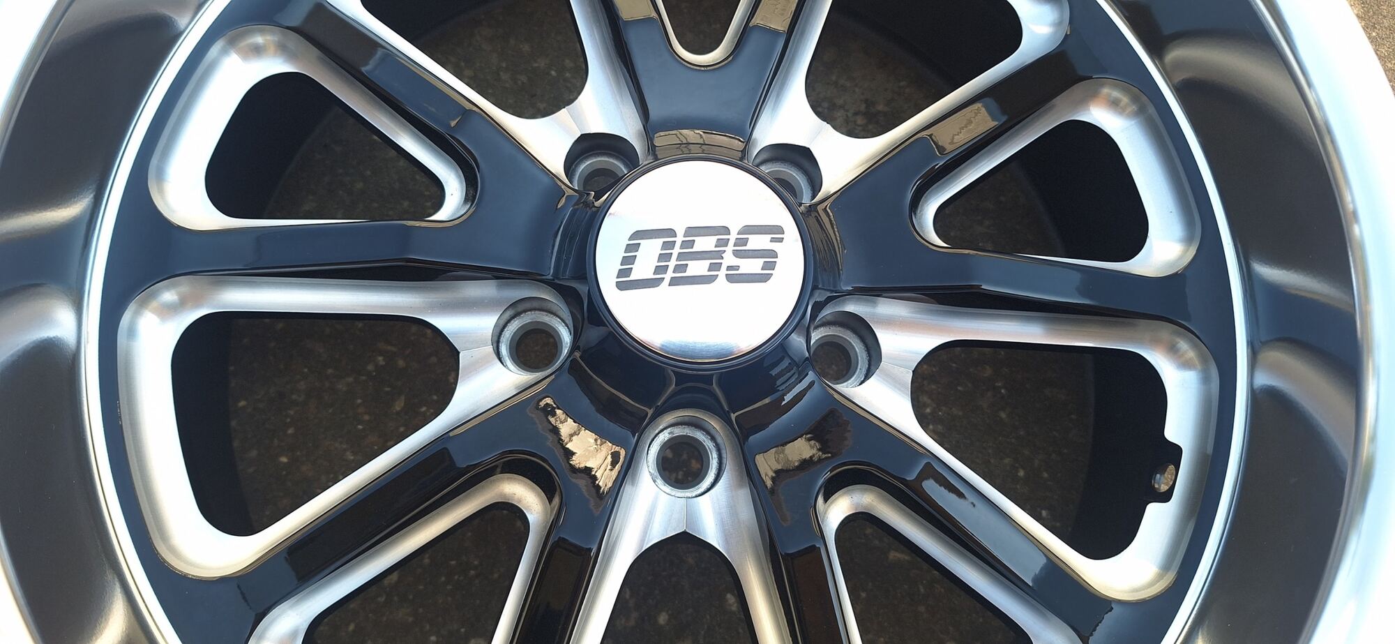 OBS logo billet center cap on a polished wheel